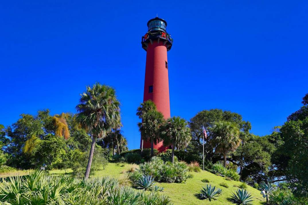 Jupiter Inlet Lighthouse red tower rising over the inlet